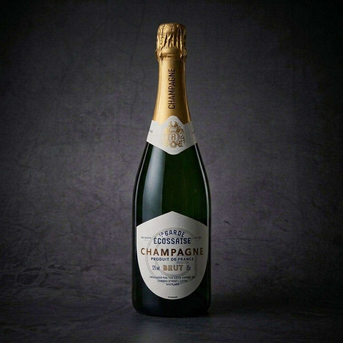 La Garde Écossaise Champagne Brut bottle on a dark slate background, a premium French champagne with historic Scottish ties selected for flagship luxury gifting.